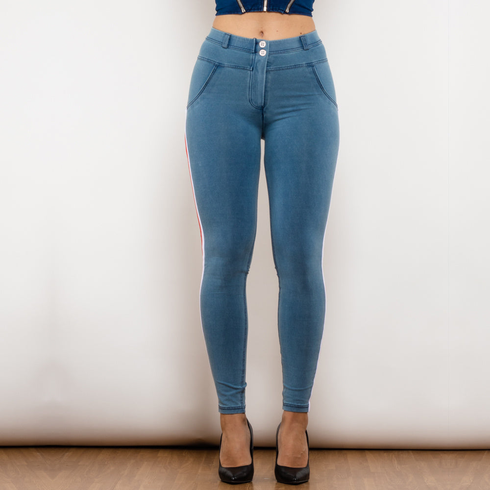 a woman wearing blue jeans and a blue top