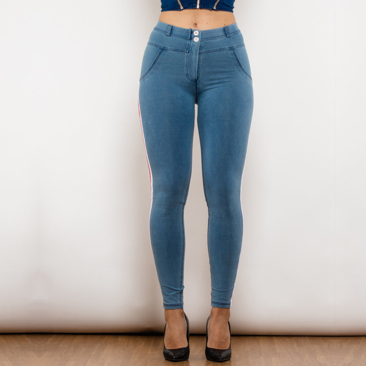 a woman wearing blue jeans and a blue top
