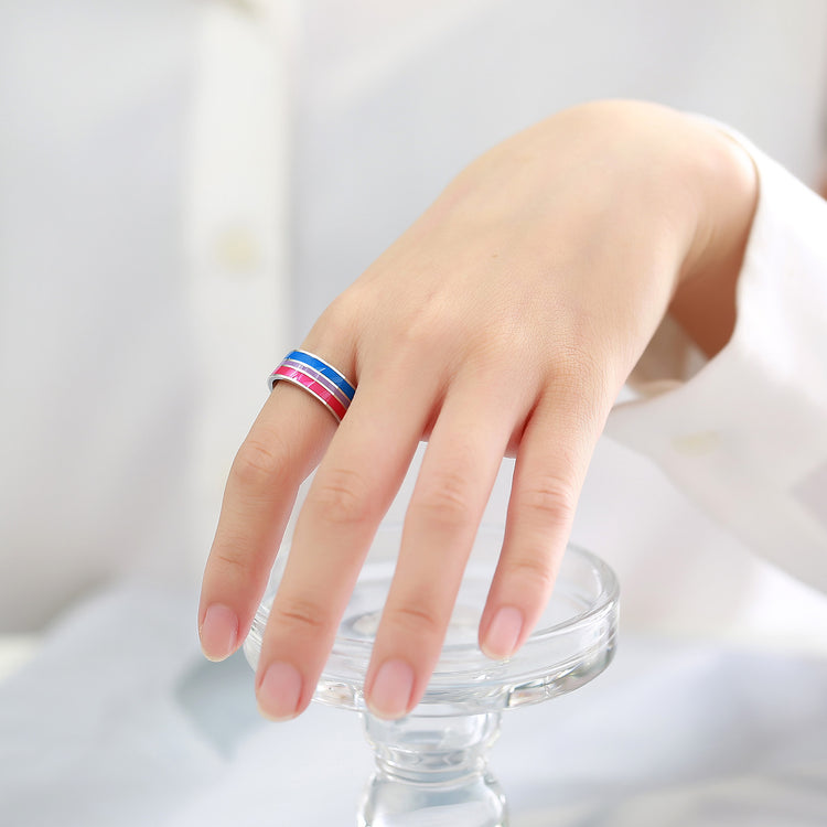 a hand with a ring on a glass stand