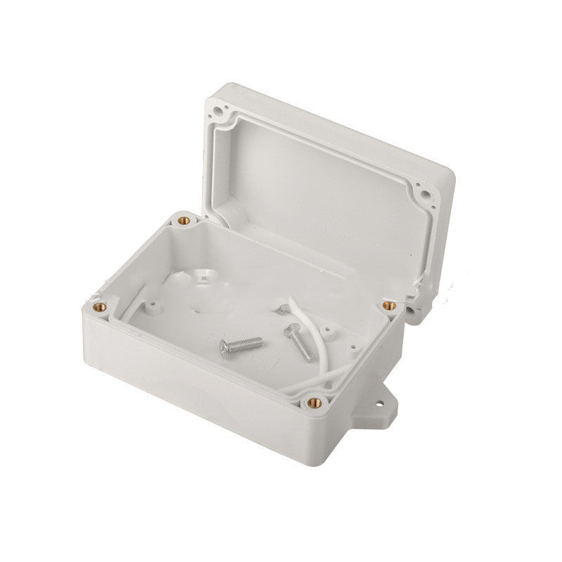 a white plastic box with screws