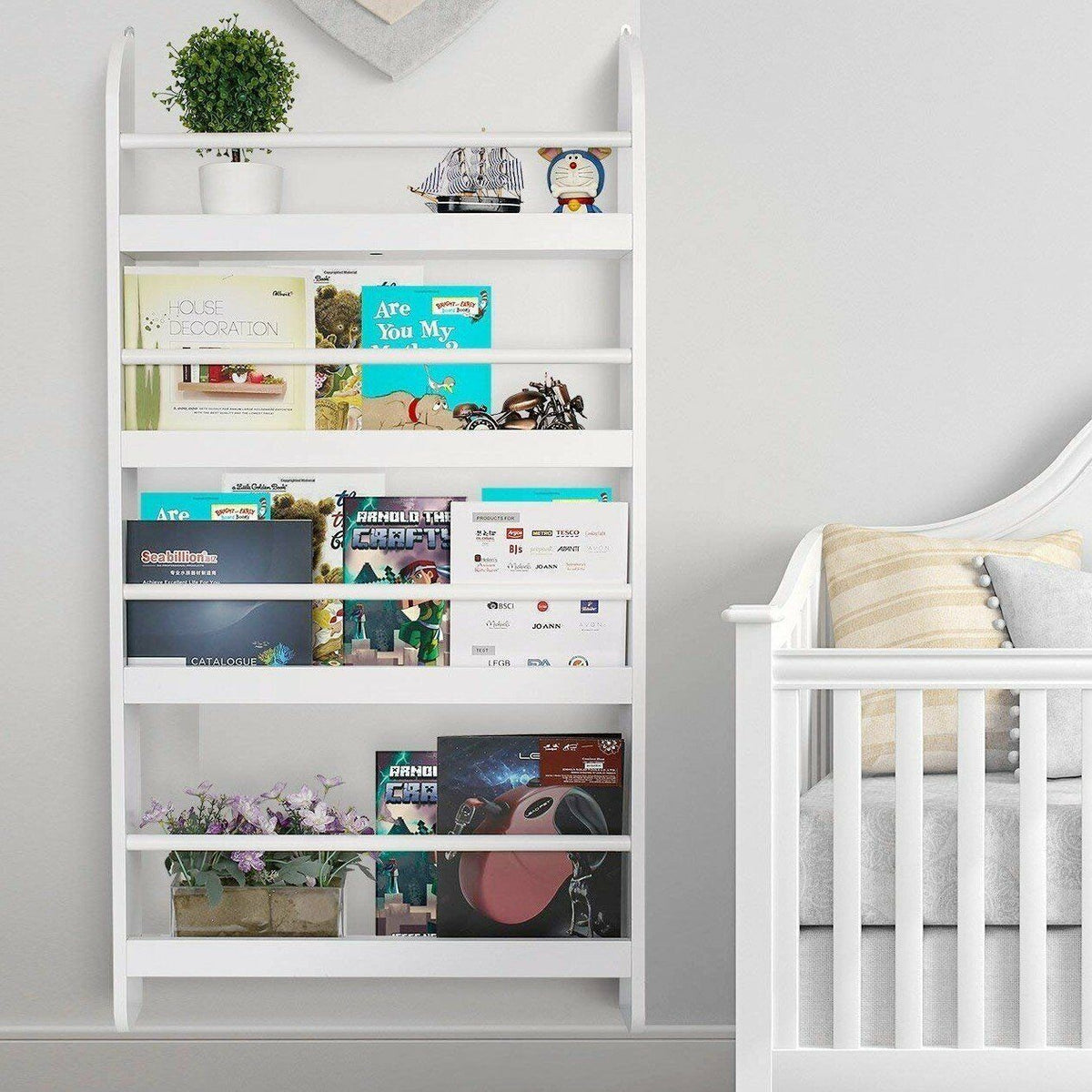a white shelf with books and a crib