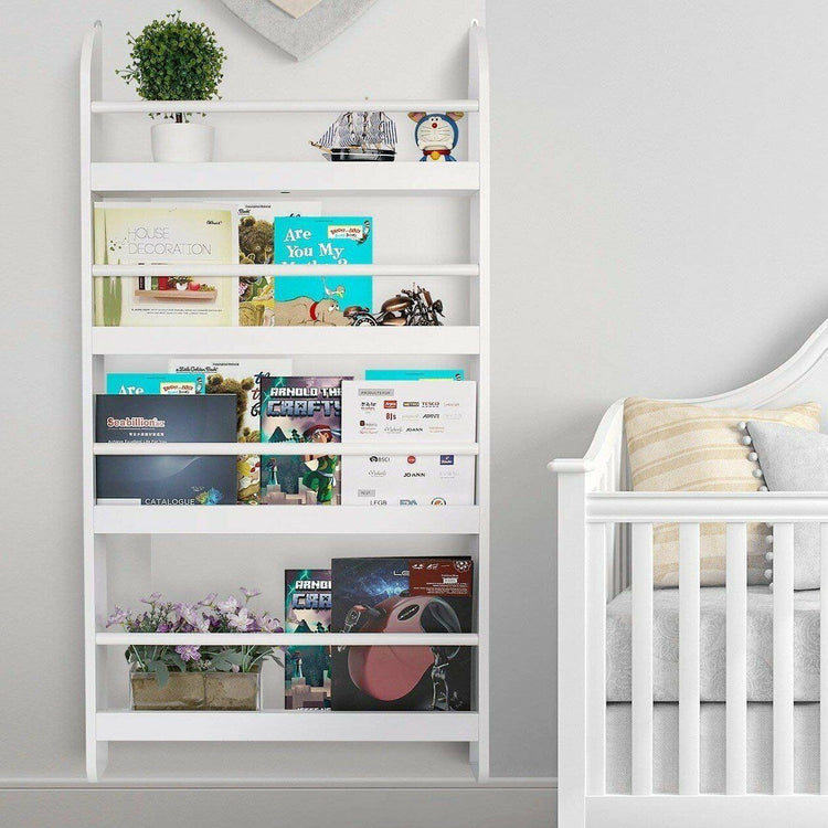 a white shelf with books and a crib