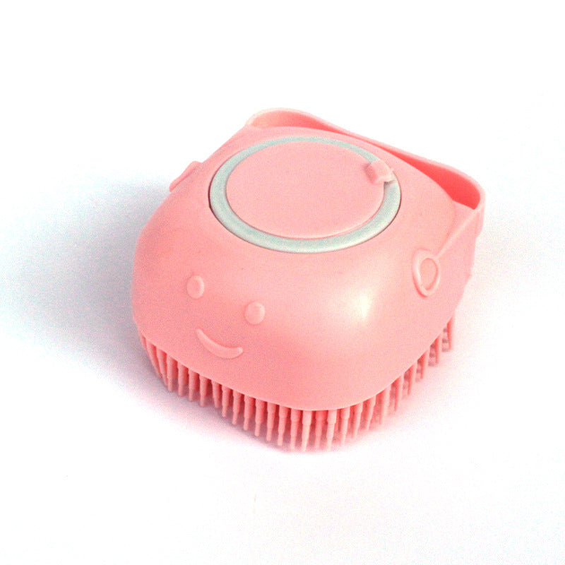 a pink plastic brush with a face on it