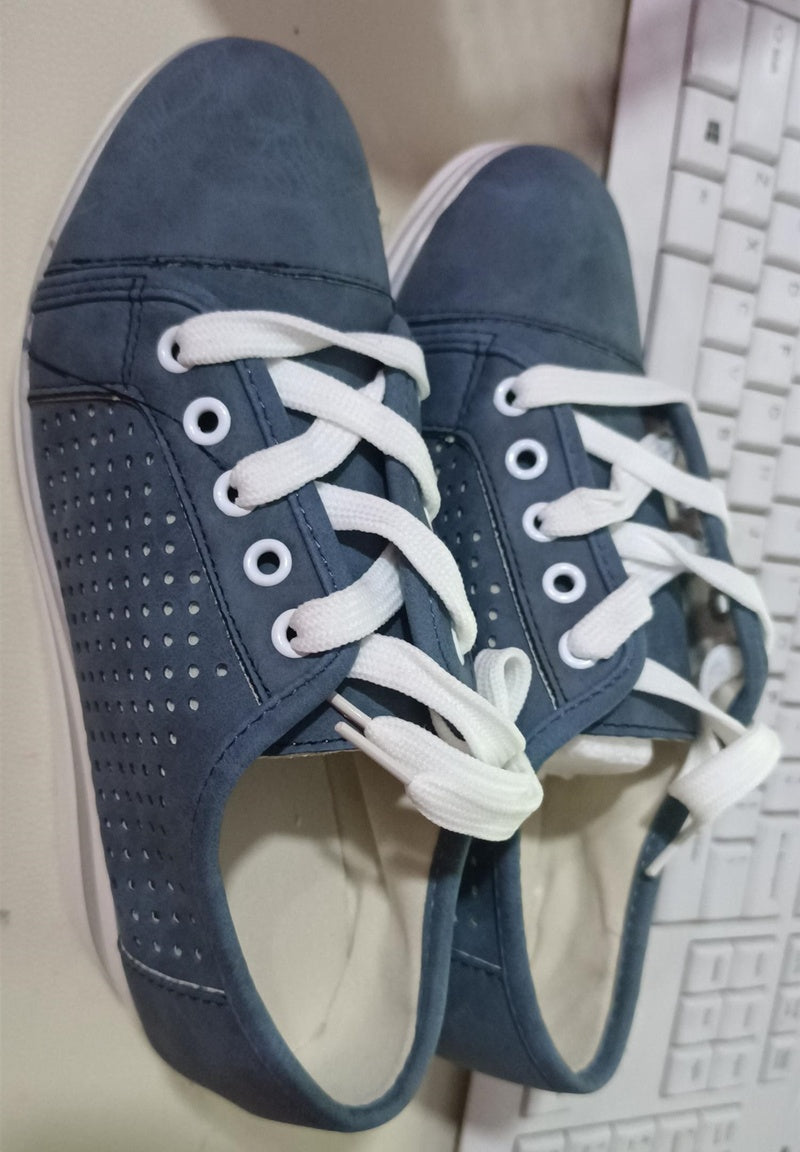 a pair of blue shoes on a keyboard