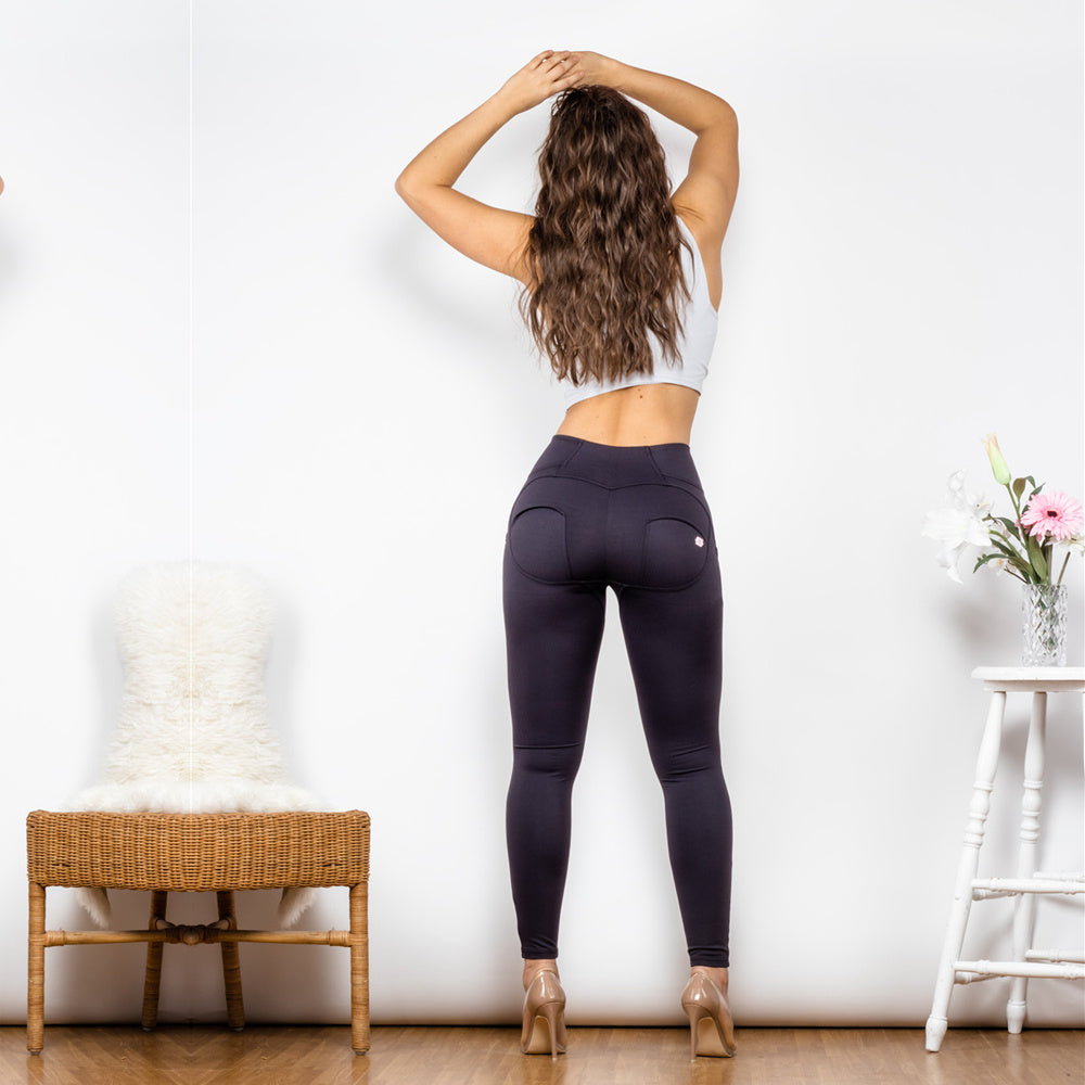 a woman in tight pants and a white top