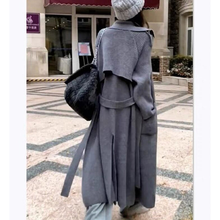 a woman wearing a grey coat and beanie
