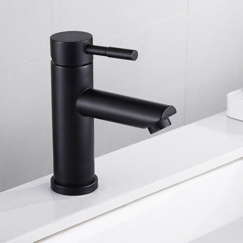 a black faucet on a counter