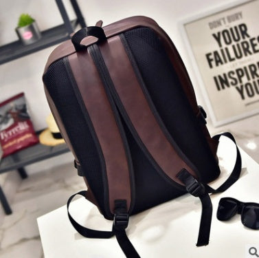 a brown and black backpack on a white table