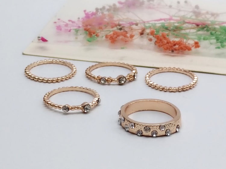 a group of gold rings with diamonds