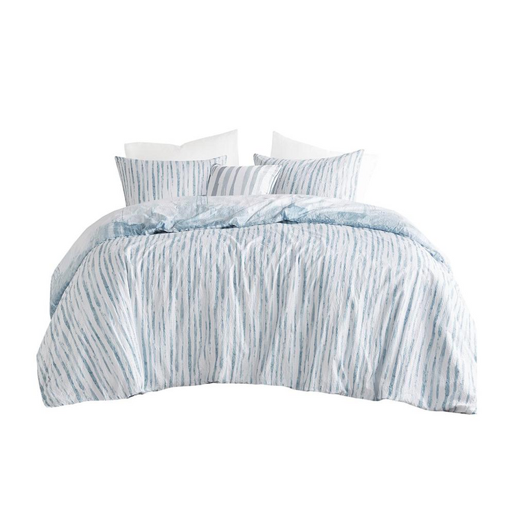 a bed with blue and white striped comforter