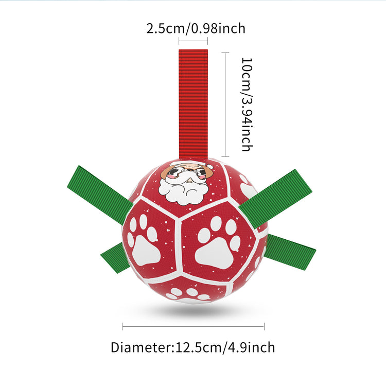 a red ball with white paw prints and green straps