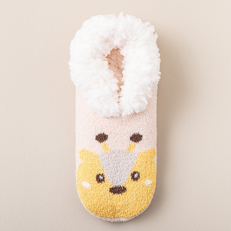 a white and pink fuzzy slipper with a cartoon animal design