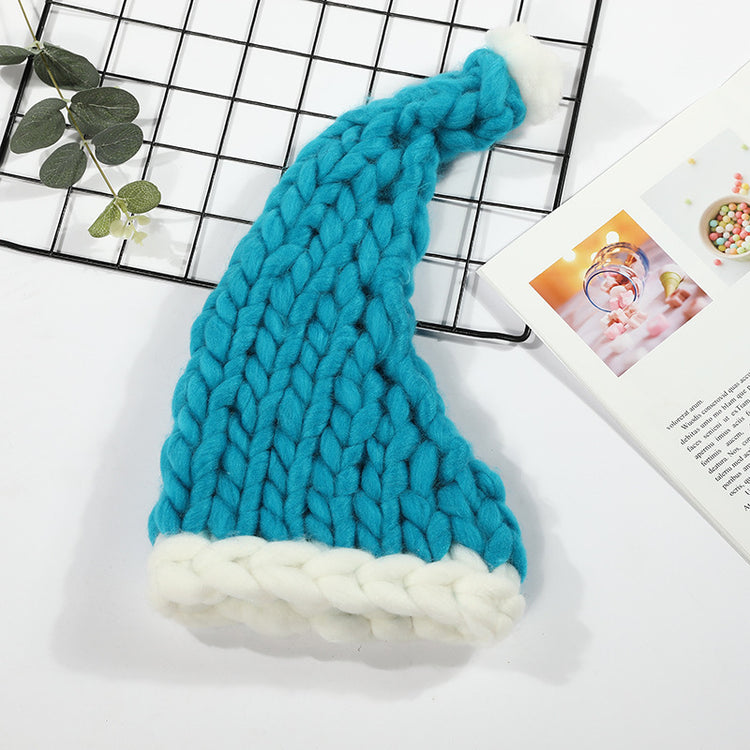 a blue and white knit hat on a grid