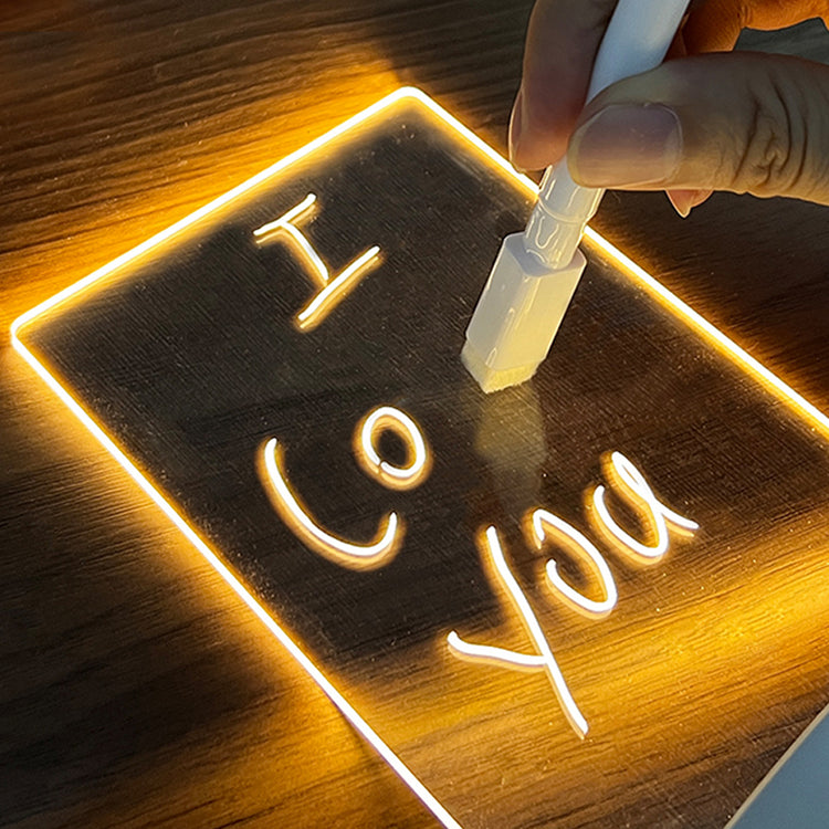 a hand writing on a glass surface