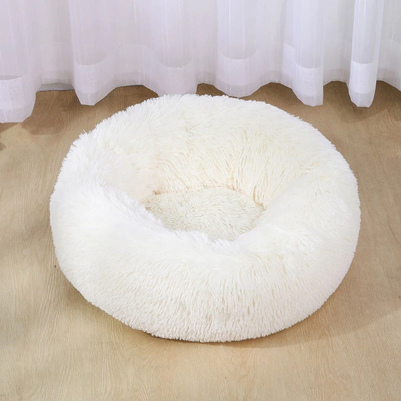 a white fluffy dog bed
