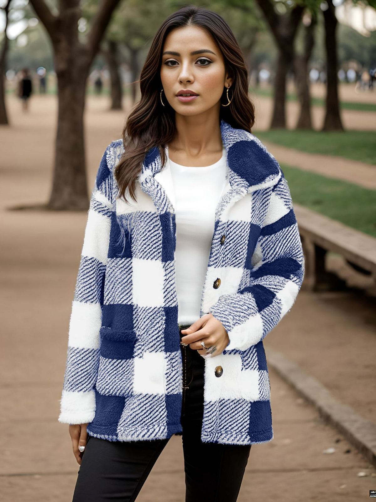 a woman standing outside in a park