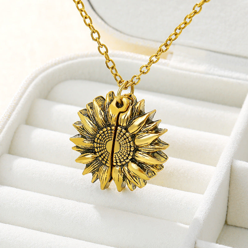 a gold sunflower necklace in a jewelry box