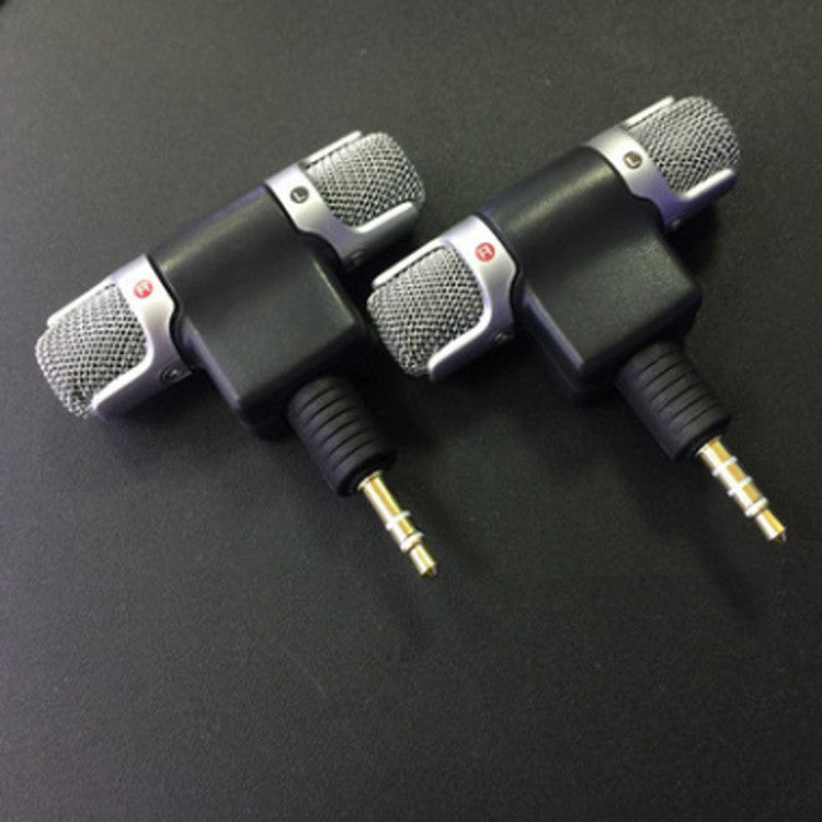 a pair of microphones on a black surface