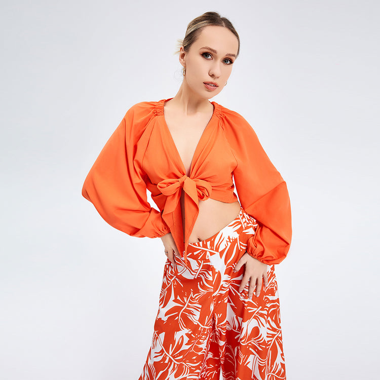 a woman in orange top and skirt