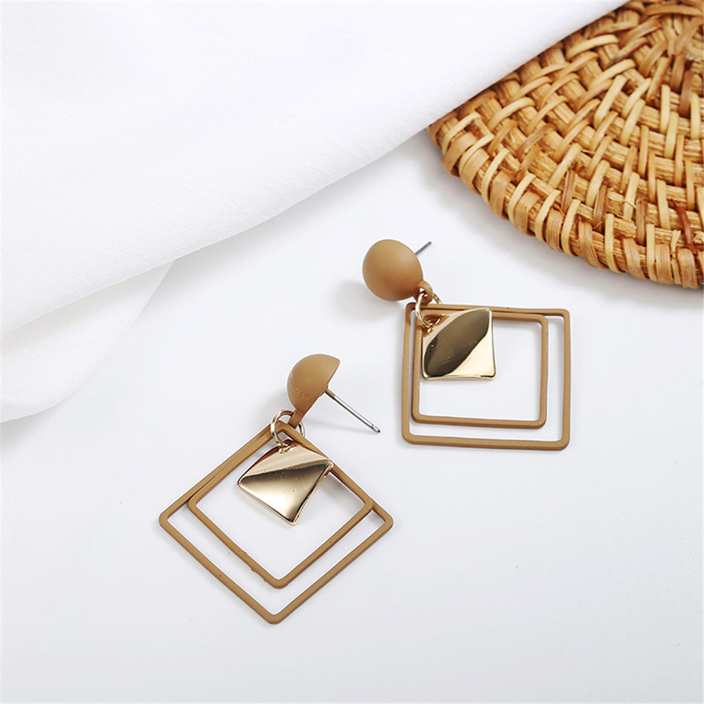 a pair of gold earrings