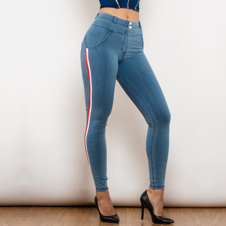 a woman wearing blue jeans and black heels