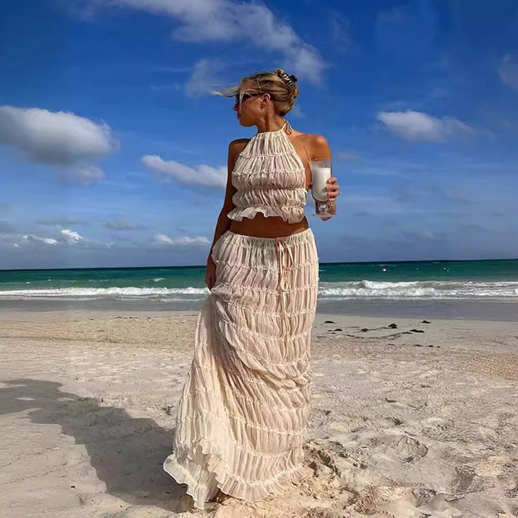 a woman in a white dress on a beach