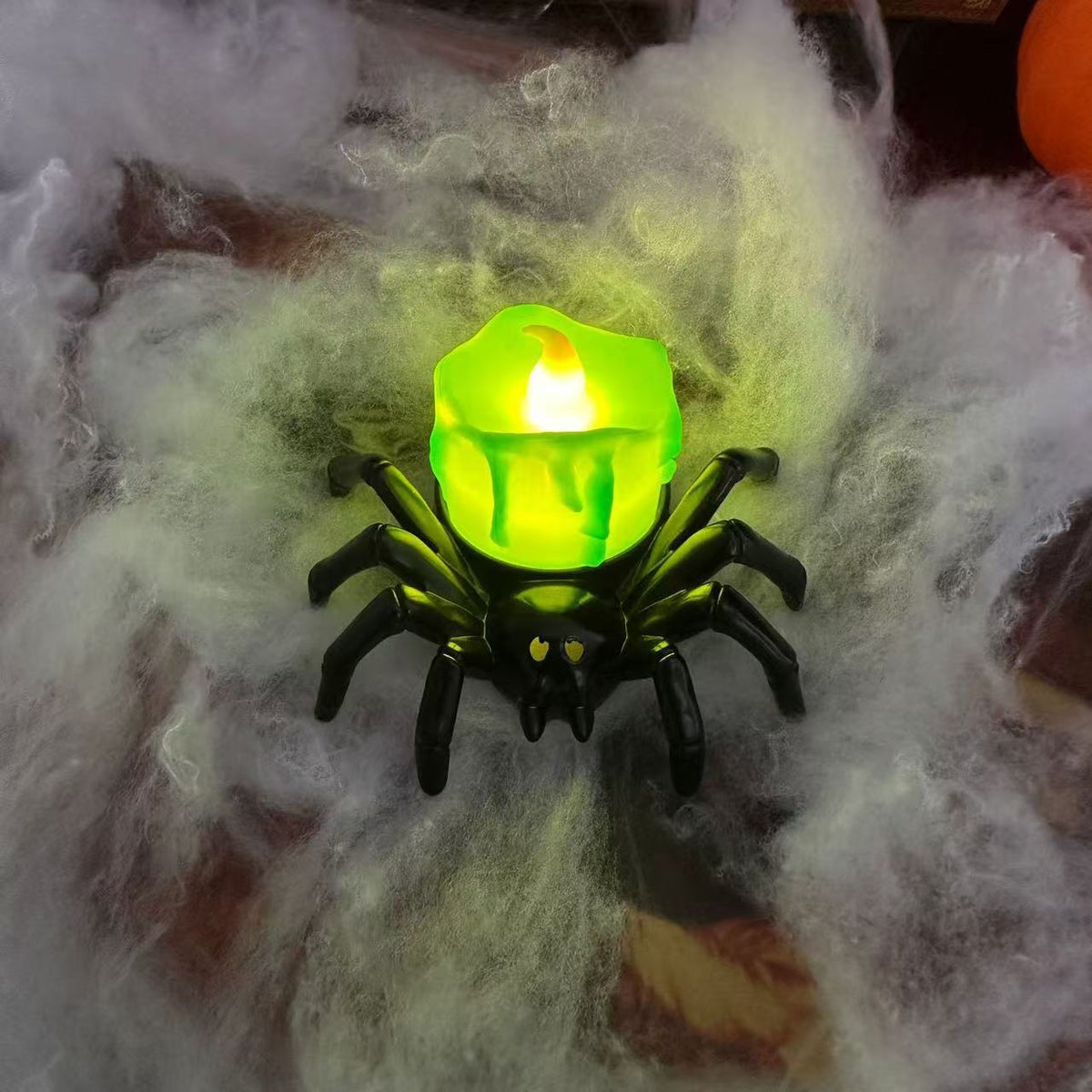 a toy spider with a candle in it