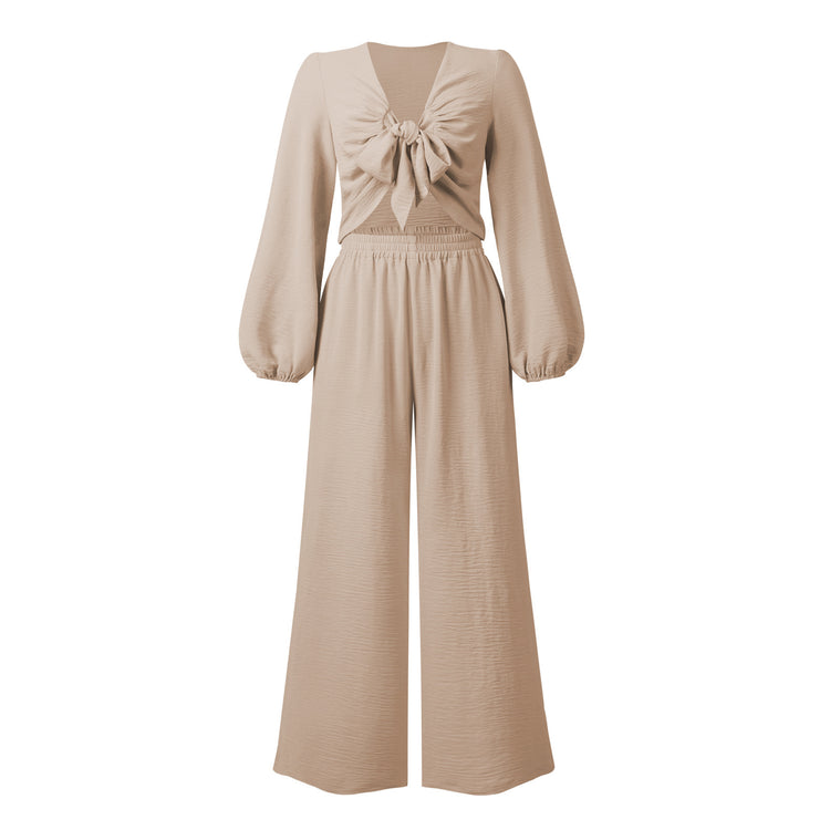 a beige outfit with a bow on it