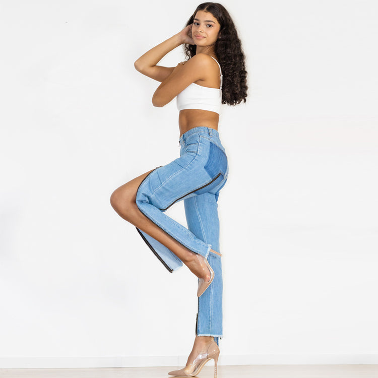 a woman in a white top and blue jeans