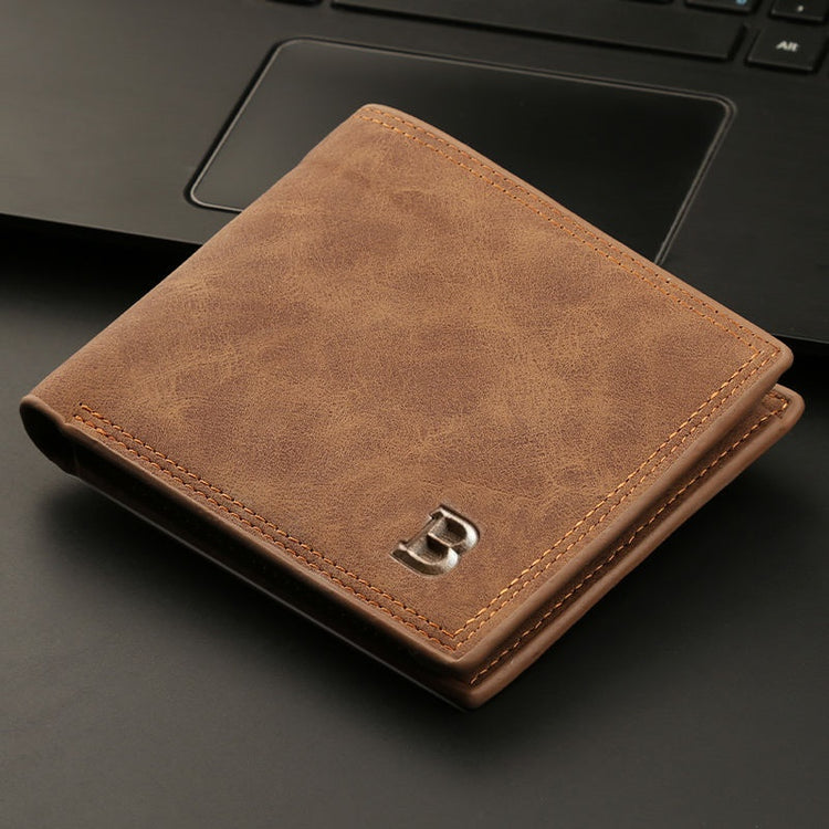 a brown wallet on a black surface
