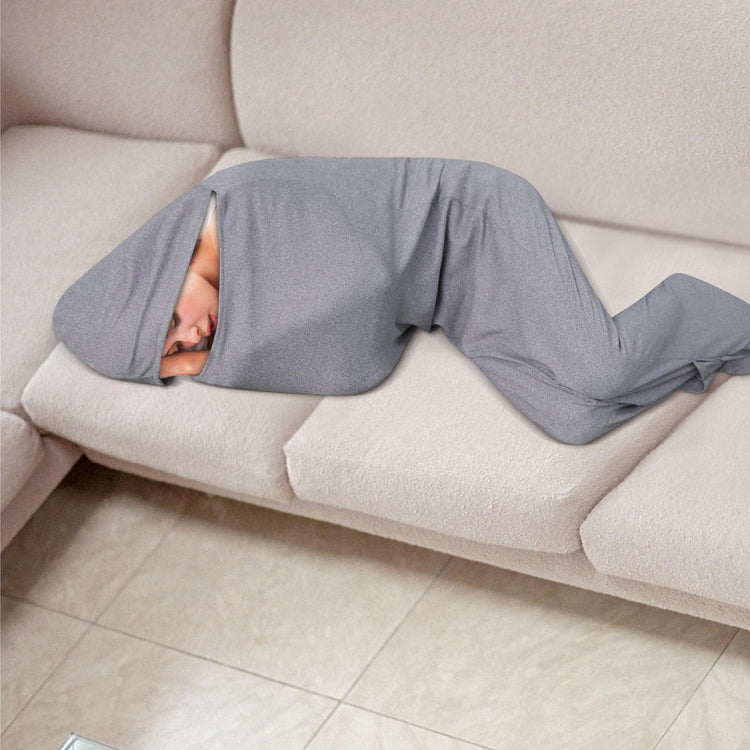 a person wrapped in a blanket on a couch