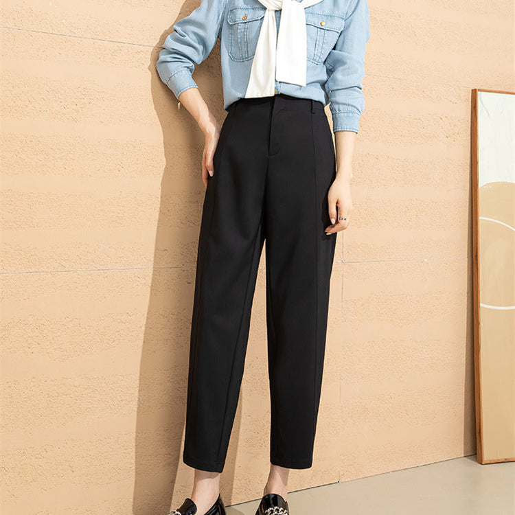 a woman standing against a wall