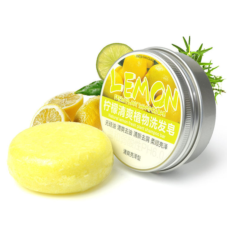a jar of lemon soap next to lemons