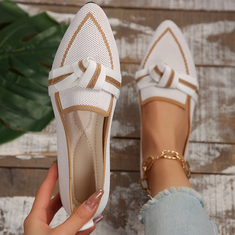 a person holding a white loafer