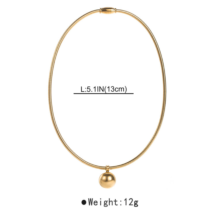 a gold necklace with a ball pendant