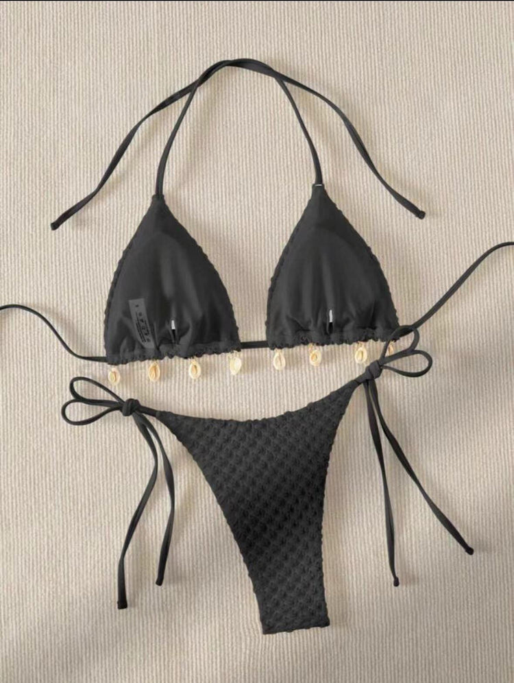a black garment with white shells on it