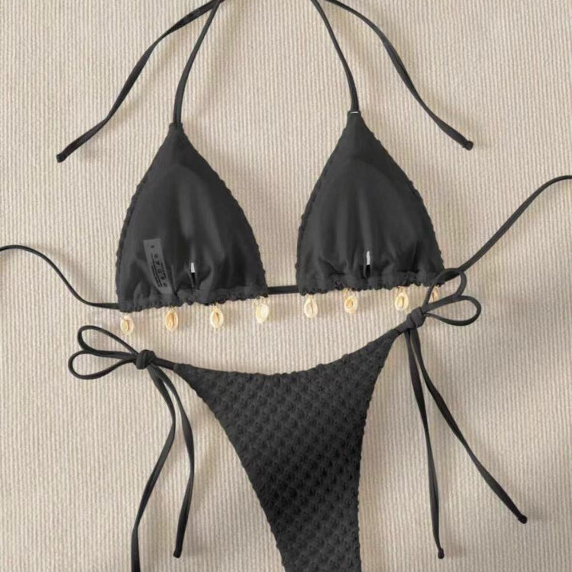 a black garment with white shells