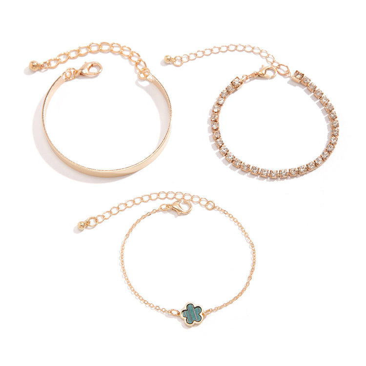 a group of gold bracelets