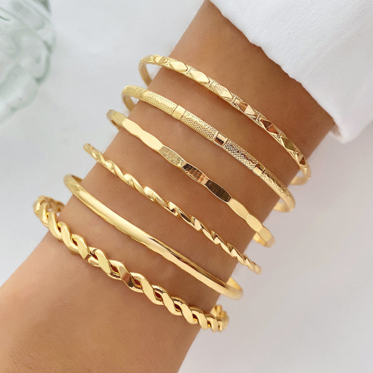 a person wearing gold bracelets
