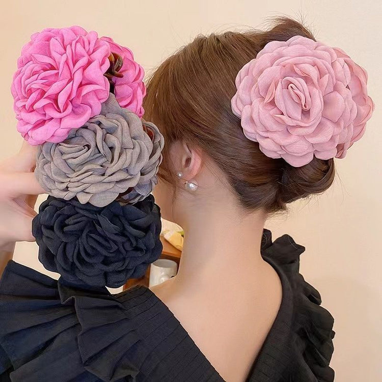 a woman holding flowers in her hair