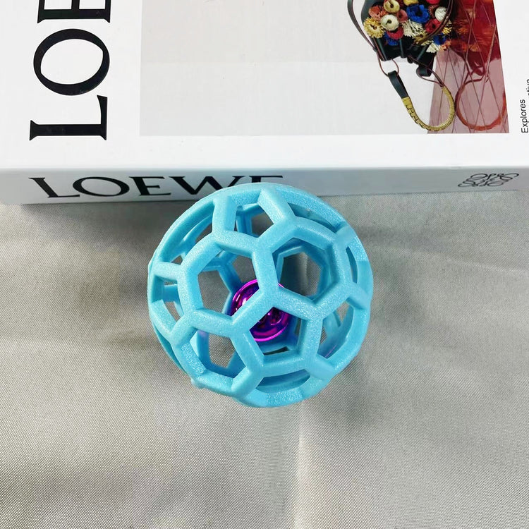 a blue ball with a purple ball on top of a white box