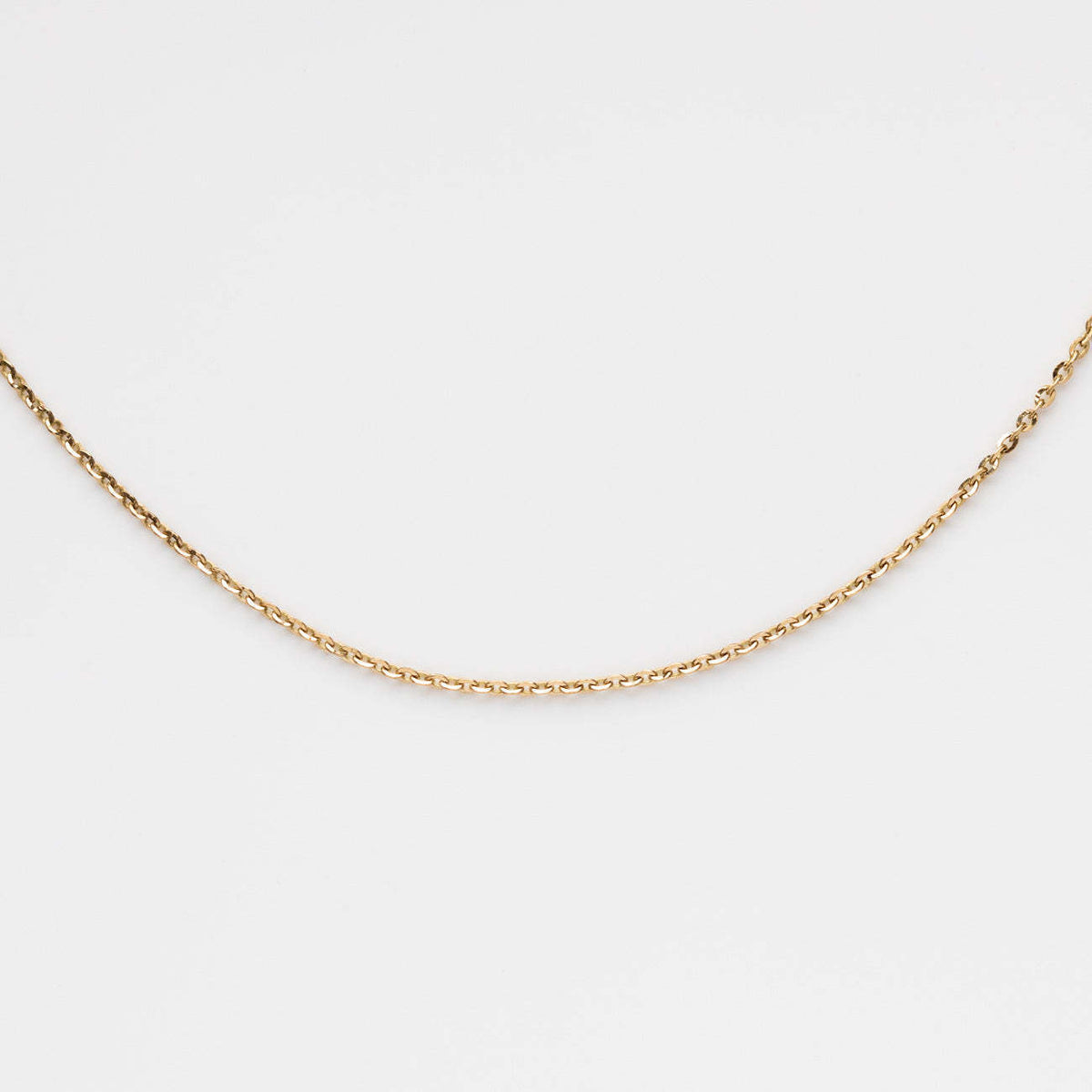 a gold chain on a white background