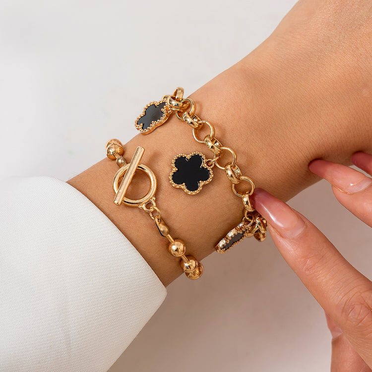 a person wearing a gold bracelet