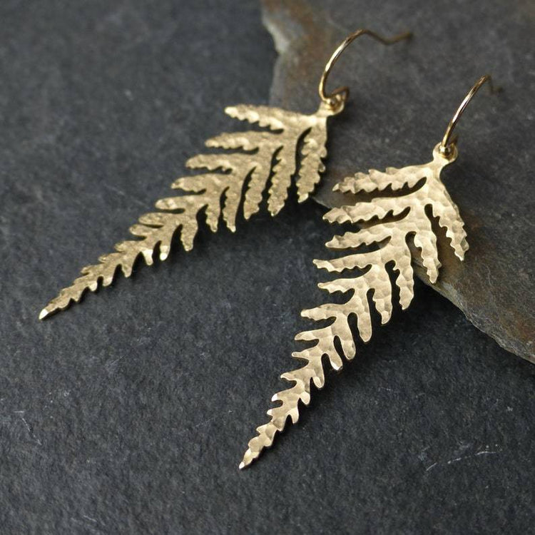 a pair of earrings on a rock