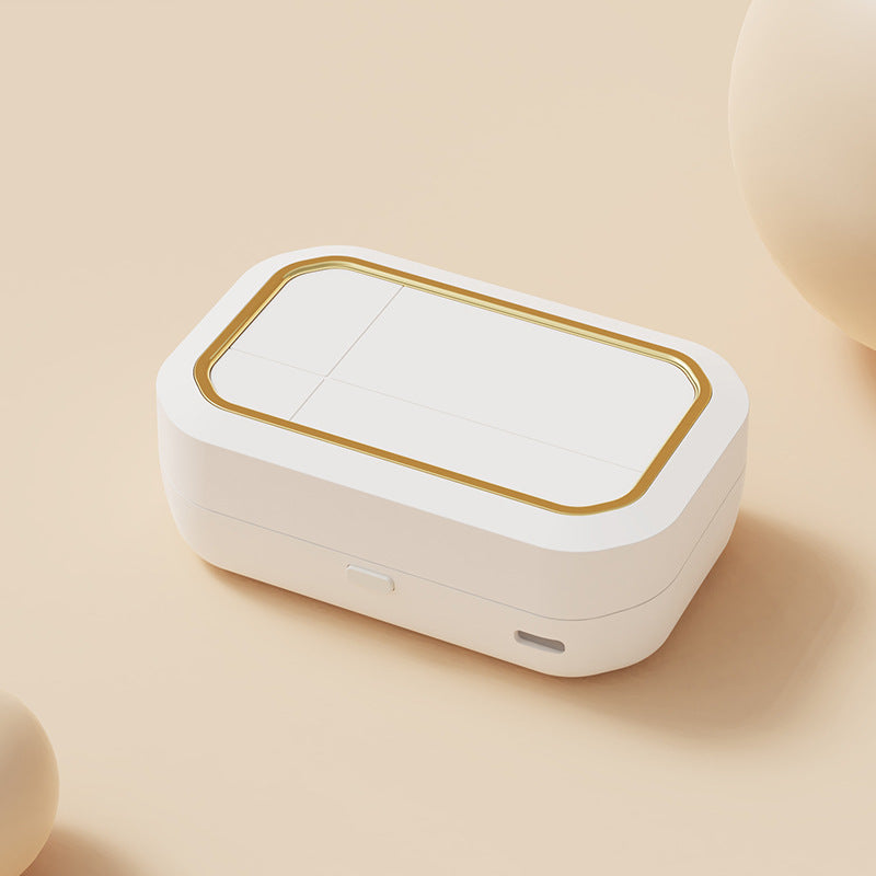 a white rectangular object with a gold border