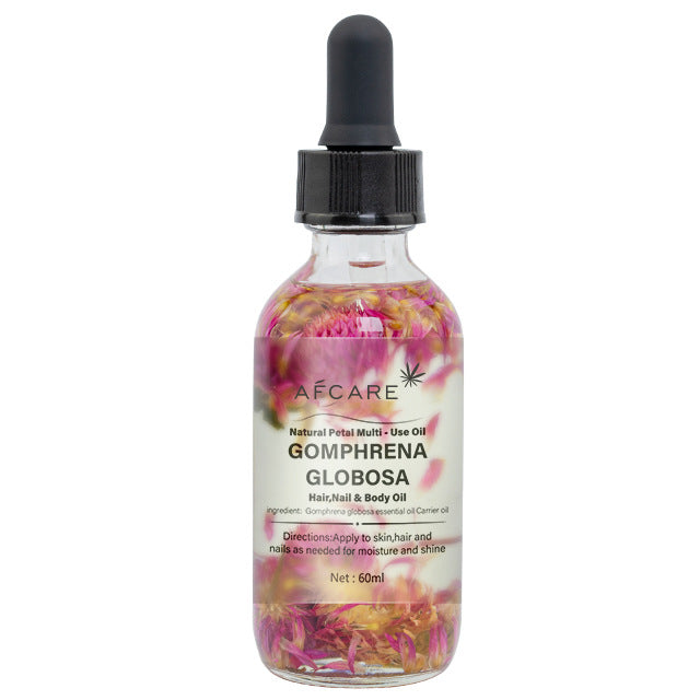 a bottle of oil with pink flowers