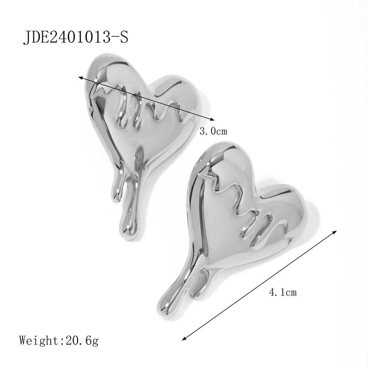 a pair of silver hearts with measurements