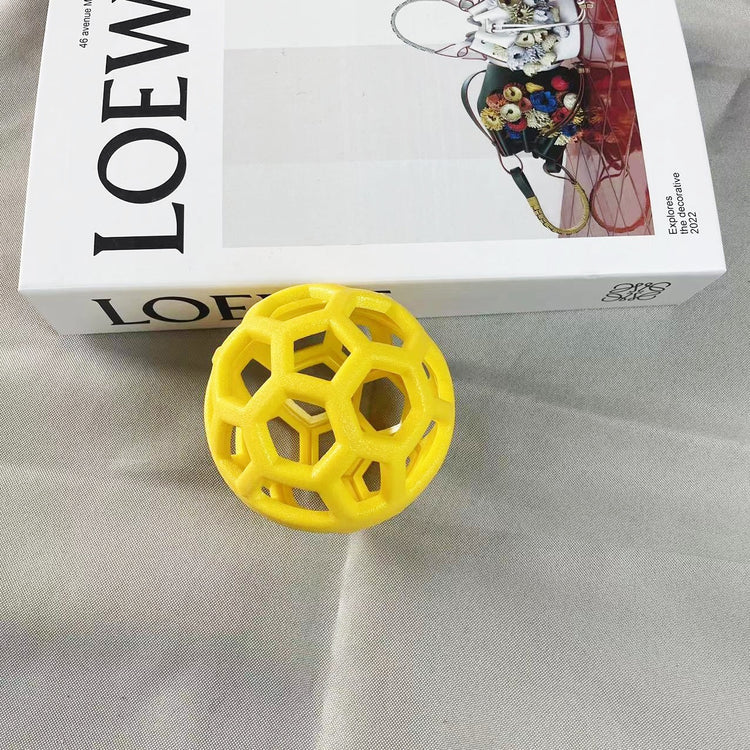 a yellow ball next to a box