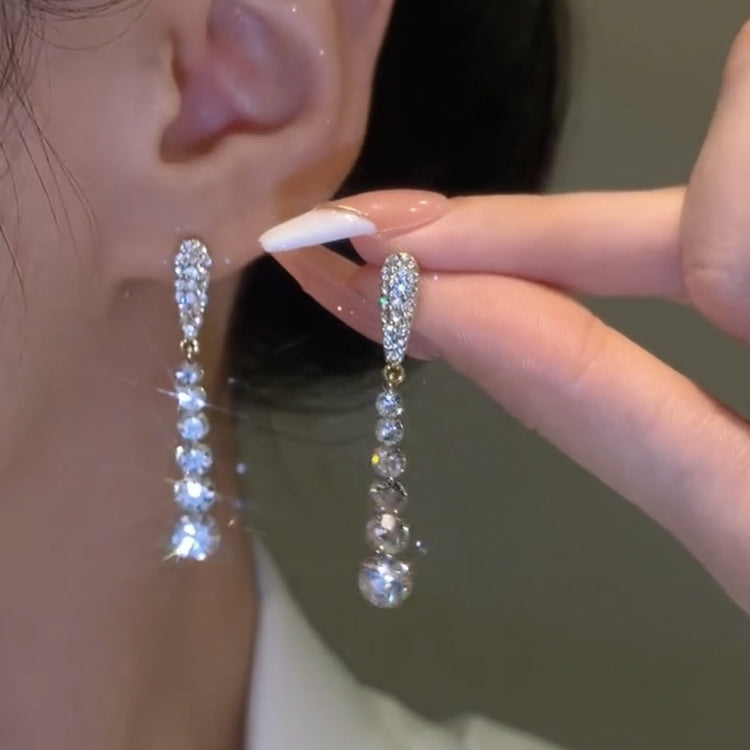 a person wearing a pair of earrings