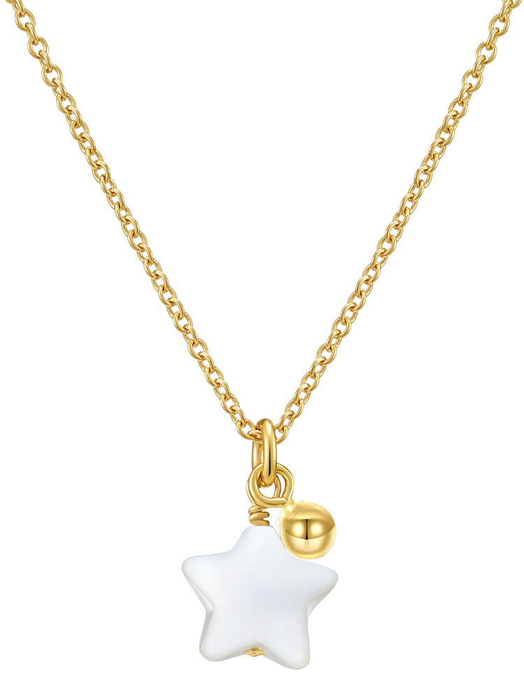 a gold chain with a white star pendant